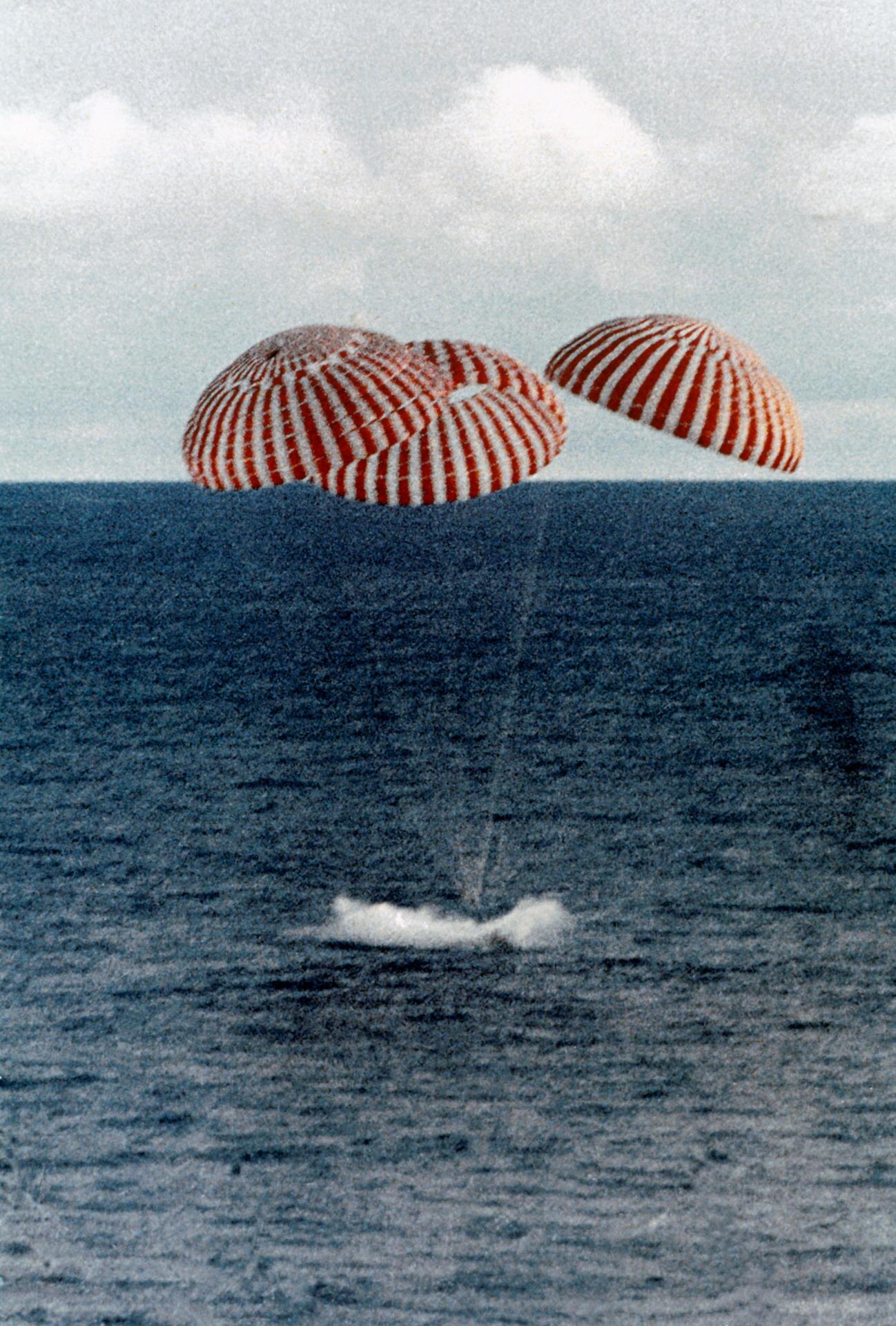 Apollo 13 Command Module descending under parachutes toward the Pacific Ocean