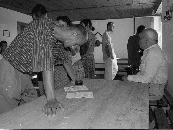 Christians gathered closely around a table in a modest room