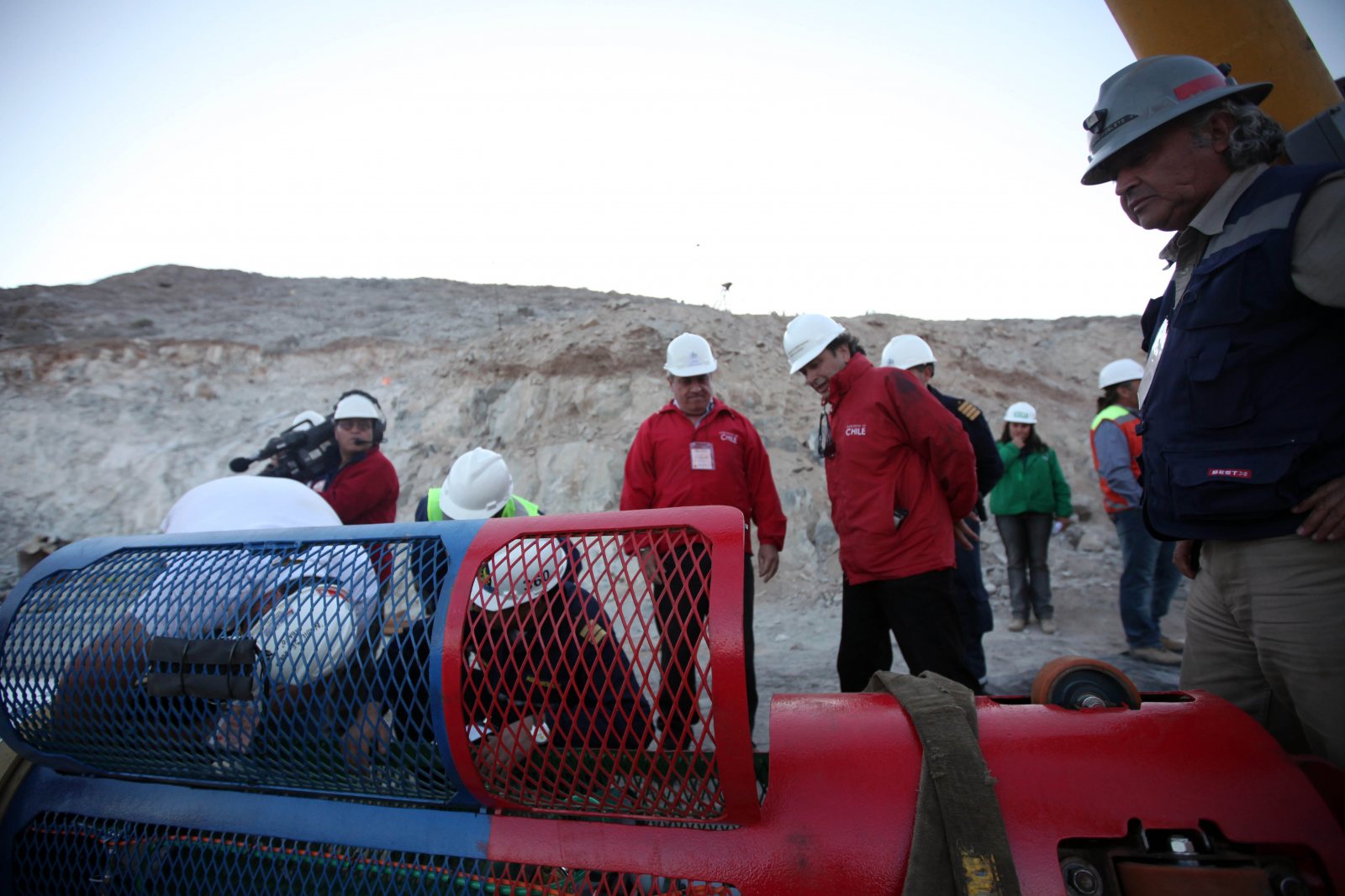 Officials inspecting the Fénix 2 rescue capsule at the San José mine